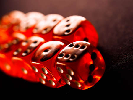 Red gambling dices on black background