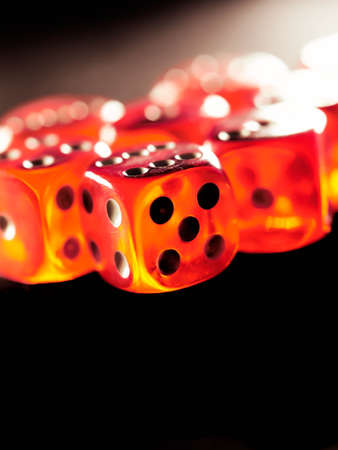 Red gambling dices on black background