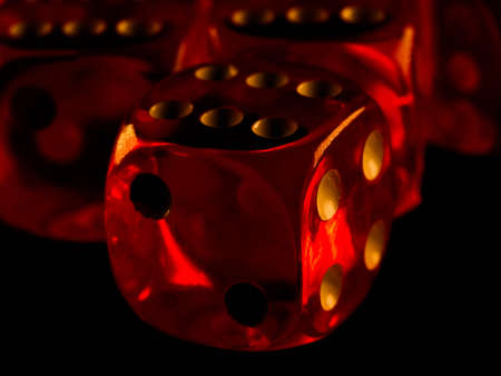 Red gambling dices on black backgroundの写真素材