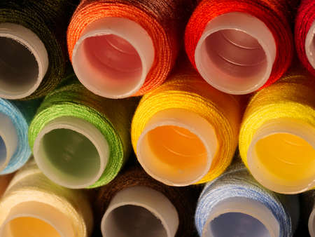 Sewing threads multicolored background closeup
