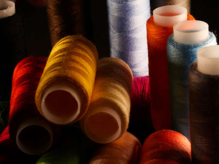 Sewing threads multicolored background closeup