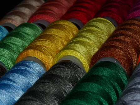 Sewing threads multicolored background closeup