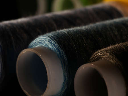 Sewing threads multicolored background closeup