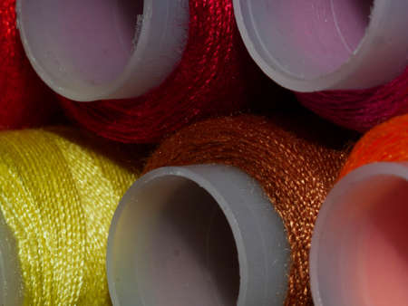 Sewing threads multicolored background closeup