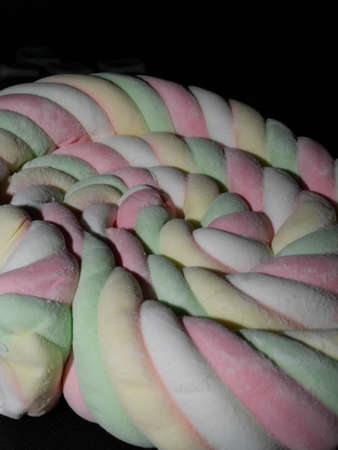 Background of twisted, colorful marshmallow, close up, macroの写真素材
