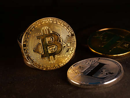Crypto currency background with various of shiny silver and golden physical cryptocurrencies symbol...