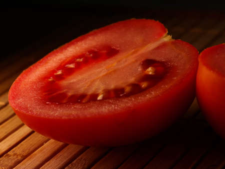 Close-up of fresh, ripe tomatoes on wood background