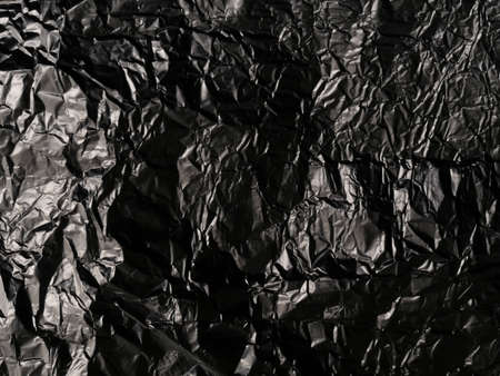 Thin sheet of silver leaf background with shiny uneven surfaceの写真素材