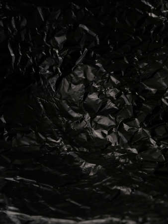 Thin sheet of silver leaf background with shiny uneven surface