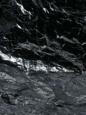 Thin sheet of silver leaf background with shiny uneven surfaceの写真素材
