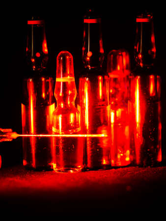 Medical ampoules close up. Many ampoules. Glass ampoules on the table. Scattered ampoules with medicine.の写真素材