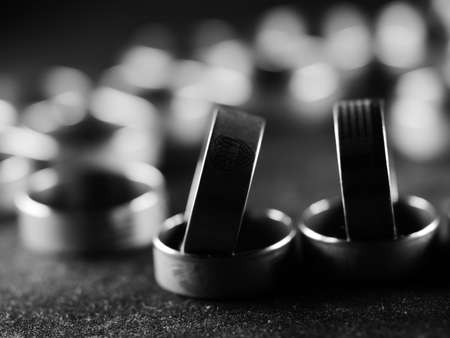 A lot of costume jewelry, jewelry made of gold and silver, lie on a black surface. Women's day,...