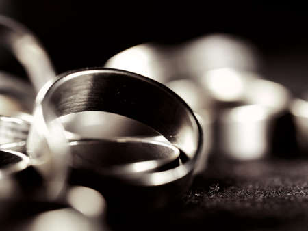 A lot of costume jewelry, jewelry made of gold and silver, lie on a black surface. Women's day, stylish image, accessories. Wardrobe addition, style, metalの写真素材