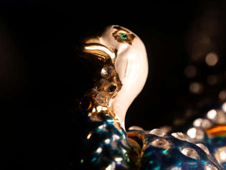 figurine of a peacock and jeweler bracelet of the bride. Vintage metal bird figurines.の写真素材