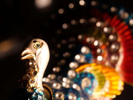 figurine of a peacock and jeweler bracelet of the bride. Vintage metal bird figurines.の写真素材