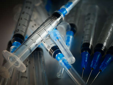 Several syringe on white table prepared for injection in hospital, selective focus, DOF, macroの写真素材