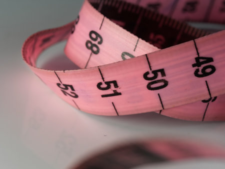 Close up tailor measuring tape on white table background. White measuring tape shallow depth of...