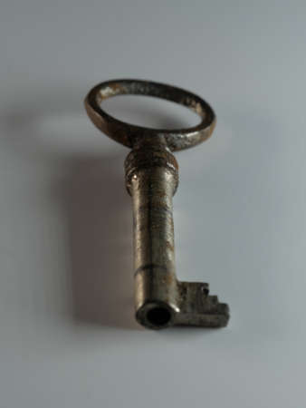 A golden key isolated on white background. Old rusty door key. Antique gold key. DOF.の写真素材