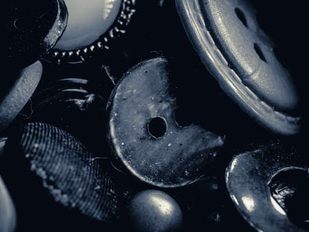 Grayscale photo of buttons. Collection of assorted spare clothes buttons. Macro. DOFの写真素材