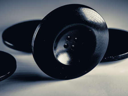 Grayscale photo of buttons. Collection of assorted spare clothes buttons. Macro. DOFの写真素材