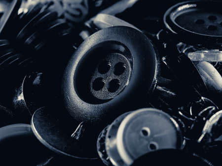 Grayscale photo of buttons. Collection of assorted spare clothes buttons. Macro. DOFの写真素材