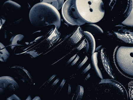 Grayscale photo of buttons. Collection of assorted spare clothes buttons. Macro. DOFの写真素材