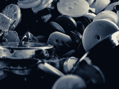 Grayscale photo of buttons. Collection of assorted spare clothes buttons. Macro. DOFの写真素材