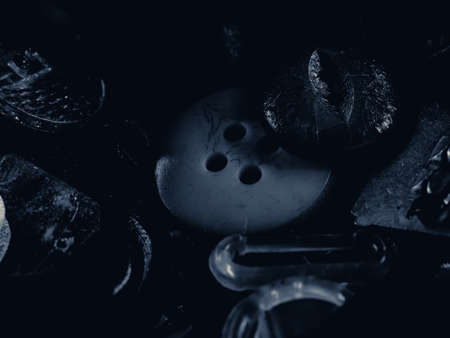 Grayscale photo of buttons. Collection of assorted spare clothes buttons. Macro. DOFの写真素材
