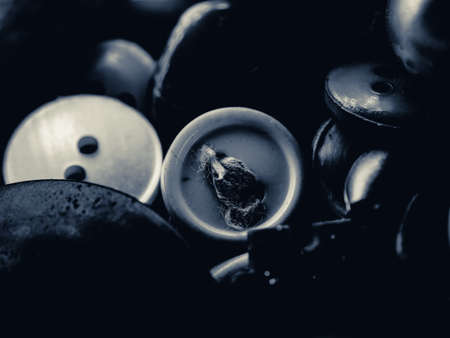 Grayscale photo of buttons. Collection of assorted spare clothes buttons. Macro. DOFの写真素材