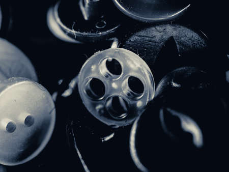 Grayscale photo of buttons. Collection of assorted spare clothes buttons. Macro. DOFの写真素材