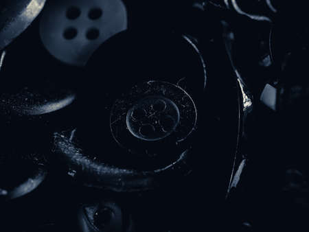 Grayscale photo of buttons. Collection of assorted spare clothes buttons. Macro. DOFの写真素材
