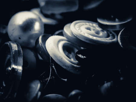 Grayscale photo of buttons. Collection of assorted spare clothes buttons. Macro. DOFの写真素材