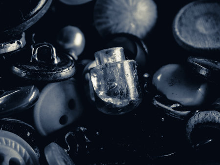 Grayscale photo of buttons. Collection of assorted spare clothes buttons. Macro. DOF