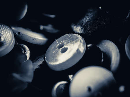 Grayscale photo of buttons. Collection of assorted spare clothes buttons. Macro. DOFの写真素材