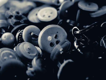 Grayscale photo of buttons. Collection of assorted spare clothes buttons. Macro. DOFの写真素材
