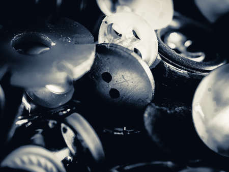 Grayscale photo of buttons. Collection of assorted spare clothes buttons. Macro. DOF