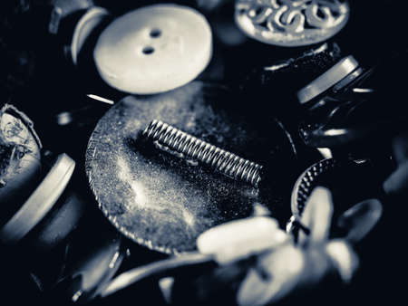 Grayscale photo of buttons. Collection of assorted spare clothes buttons. Macro. DOFの写真素材