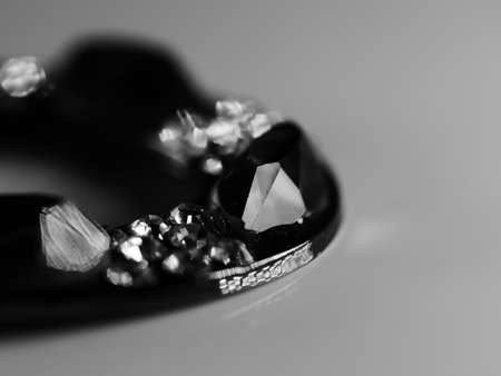 Brooch with pearls isolated on black, with diamonds, selective focus, DOF, macro, on white backgroundの写真素材