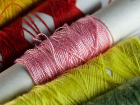 Sewing threads multicolored background closeup, selective focus, macro