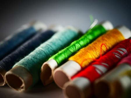 Sewing threads multicolored background closeup, selective focus, macro