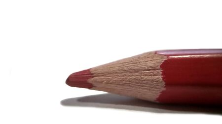 Red sharp pencil tip close-up. isolated on white background stock photoの写真素材