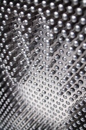 A metal pin grid array with hand shape embossed on it