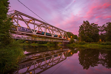 An old railway truss bridge in sunsetの写真素材