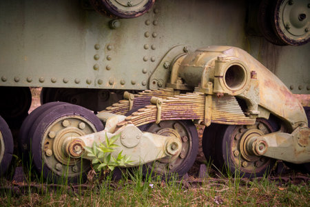Closeup of wheels, suspension and caterpillar track of an old tank