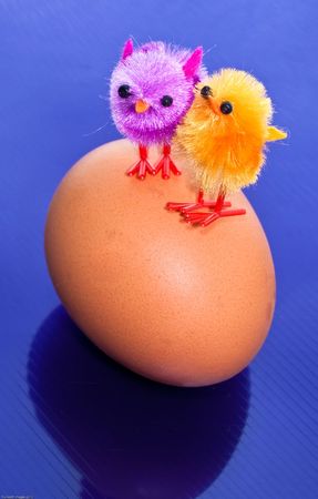 Toy chicks on an egg