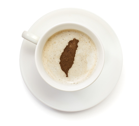 A cup of coffee with foam and powder in the shape of Taiwan.(series)の写真素材