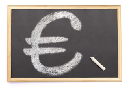 A blackboard with a chalk and the shape of the euro symbol drawn onto. (series)の写真素材