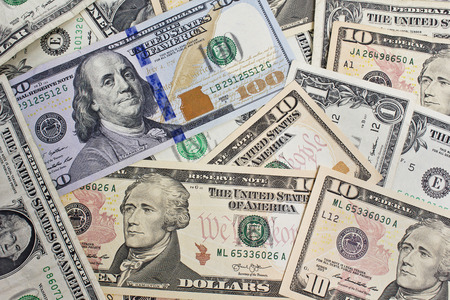 Close Up shot of several dollar bills laying chaotically around.One,ten and hundred dollar bills...