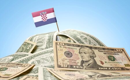 The national flag of Croatia sticking in a pile of american dollars