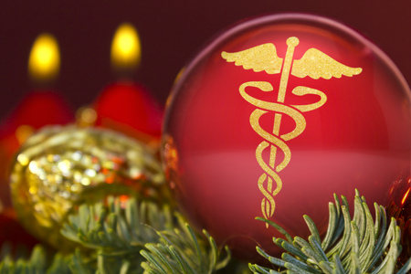 A glossy red bauble with the golden shape of an asclepius symbol.(series)の写真素材